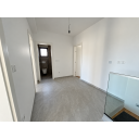 original_1790936366_minimalist-gray-tiled-hallway-with-glass-railing.png