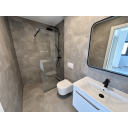 original_1790938587_modern-gray-tile-bathroom-with-black-fixtures.png
