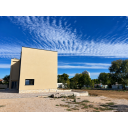 original_1792006884_modern-house-under-a-rippling-blue-sky.png