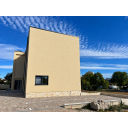 original_1792007183_modern-beige-stucco-building-under-streaked-skies.png